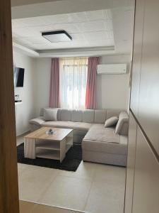 a living room with a couch and a coffee table at Apartman Đurišić in Prijevor