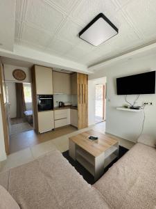a living room with a couch and a table at Apartman Đurišić in Prijevor