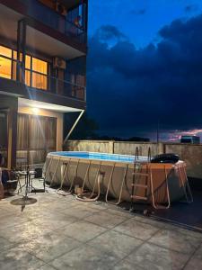 a swimming pool on the side of a building at night at Modinakhe in Kobuleti