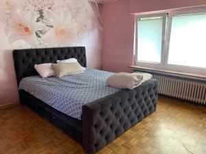 a bedroom with a bed with two pillows on it at Haus Tun in Gummersbach