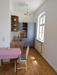 a kitchen with a table and a table and a window at Alte Dorfschule Sacro in Sacro
