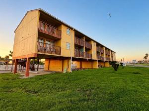 a building with balconies on the side of it at ORO North Beach Inn in Corpus Christi