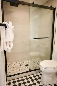 a bathroom with a glass shower with a toilet at Arkouda House in Big Bear Lake
