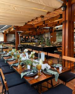 a long table with plates and napkins on it at Casa de la Luz Hotel Boutique in Mexico City