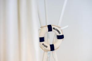 a white and blue volley ball hanging on a wall at Fördeperle Laboe in Laboe