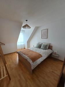 a bedroom with a bed in a attic at Charmante maison Marnaise in Vauclerc