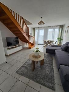 a living room with a couch and a table at Charmante maison Marnaise in Vauclerc