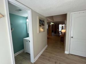 a hallway of a home with blue walls and wooden floors at Egrets Pointe, Unit 492 in Edisto Island