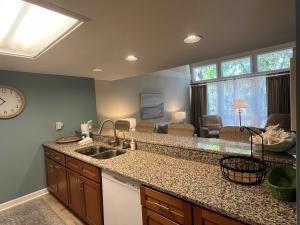 a kitchen with a sink and a living room at Egrets Pointe, Unit 492 in Edisto Island +34 photos
