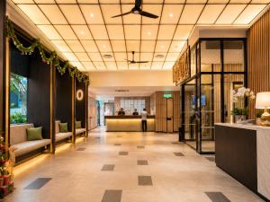 a lobby of a hotel with a person in the distance at Ceylonz Suites KLCC By KL Tower in Kuala Lumpur +46 photos