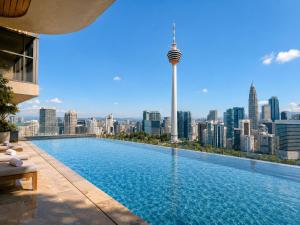 a swimming pool with a view of the city at Ceylonz Suites KLCC By KL Tower in Kuala Lumpur