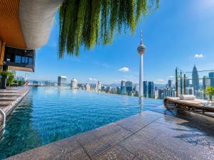 a swimming pool with a view of the city at Ceylonz Suites KLCC By KL Tower in Kuala Lumpur