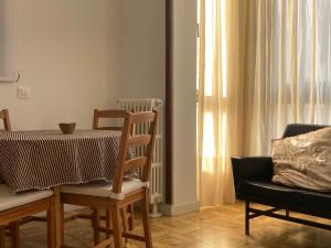 a dining room with a table and a chair at Caliu Tremp in Tremp +8 photos
