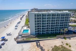 an aerial view of a hotel and the beach at Beachfront with a pool at Ocean Trillium Condo ~ 101 in New Smyrna Beach