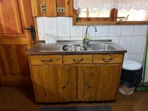 a small kitchen with a sink and a counter at Refugio Barbara Coñaripe in Coñaripe