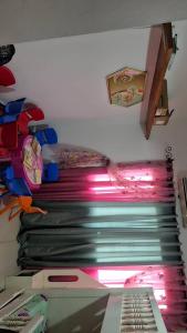 a room with a bed and a shelf withcellaneous items at Appart Bougainvillier in Libreville