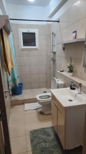 a bathroom with a toilet and a sink at Appart Bougainvillier in Libreville