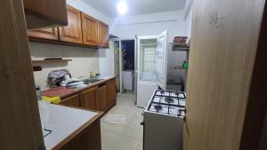 a small kitchen with a stove and a sink at Appart Bougainvillier in Libreville
