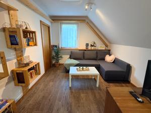 a living room with a couch and a table at Apartma Arja in Spodnje Gorje