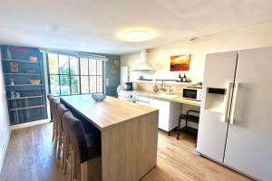 a kitchen with a wooden table and a refrigerator at Maison de charme 8p Jardin Baie de Somme in Abbeville
