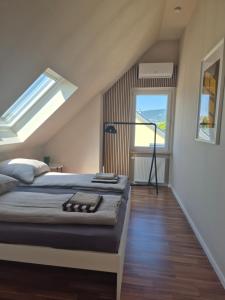 a bedroom with a bed and a large window at Rebenmeer Wohnung in Roschbach in Roschbach
