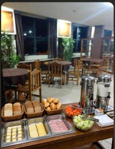 a table with some food on top of it at Stratus Vila Hotel in Volta Redonda