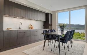 a kitchen with a table and chairs and a sink at Central apartment in quiet area in Ålesund