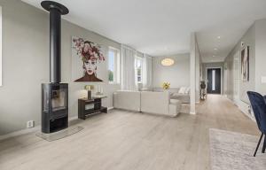 a living room with a couch and a fireplace at Central apartment in quiet area in Ålesund