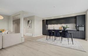 a living room with a table and some chairs at Central apartment in quiet area in Ålesund