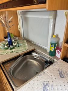 a kitchen with a sink and a counter top with a sink at Lille Ro in Giskemo