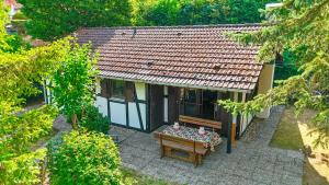 a small house with a table in front of it at Räuberlager 15 in Dammbach +17 photos