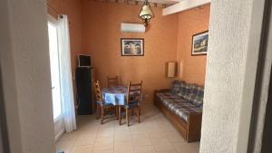 a living room with a table and a couch at Résidence Sofia Lynda in Le Plan-de-la-Tour