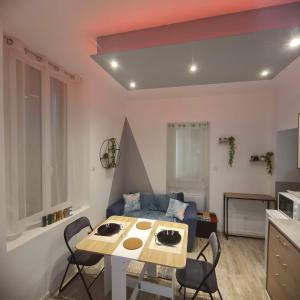 a living room with a table and a couch at Double studio en face a face in Tuchan +8 photos
