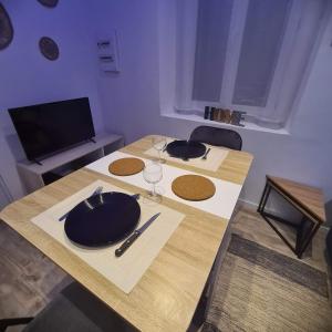 a table with a plate and wine glasses on it at Double studio en face a face in Tuchan