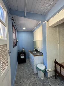 a small bathroom with a sink and a toilet at Hostel amazonia in Búzios
