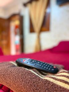 a remote control sitting on top of a bed at Cristales de Antigua Hotel Cristal in Antigua Guatemala +58 photos