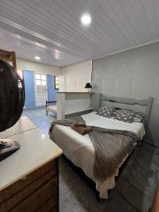 a bedroom with two beds in a room with a table at Hostel amazonia in Búzios
