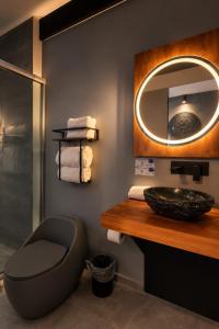 a bathroom with a toilet and a mirror at Hotel Casa Anzures in Mexico City +43 photos