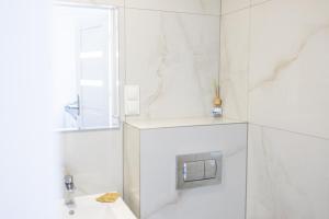a white bathroom with a sink and a mirror at Ada Niechorze in Niechorze +89 photos