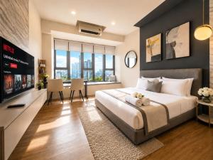 a bedroom with a large bed and a television at Ceylonz Suites KLCC By KL Tower in Kuala Lumpur