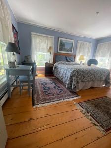 a bedroom with a bed and a desk and a table at Black Lantern B&B in Topsham