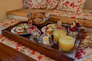a tray filled with food and drinks on a bed at Apartmány Stodola in Malá Morávka +25 photos