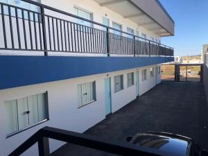 a balcony of a building with a parking lot at Vêneto Flat Residence (AP-13) in Primavera do Leste