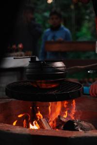 a pot sitting on top of a fire at Tupa Lodge Selva y Rio in Puerto Iguazú