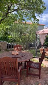 a wooden table and two chairs sitting next to a table and bench at Little Paradise - charming apartment in Labin