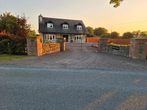 a house with a gate in front of a driveway at White Quarry Hse Quarry Road in Navan