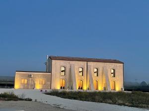 a large building with its lights on at U Minnulitu in Caltagirone