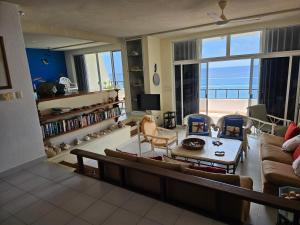 a living room with a view of the ocean at Cantamar 401, huge condo , incredible views, Sargassum Free in Cozumel