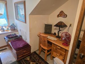 a room with a desk with a lamp and a chair at Hideaway from the Twin Cities in Houlton