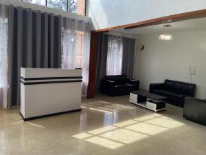 a living room with a couch and a table at Khartoum Nights in Kigali